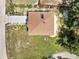 Aerial view of the home with a brown roof, green surroundings, and ample driveway space at 2004 Prescott Blvd, Deltona, FL 32738