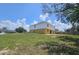 The rear exterior of the home showcases a concrete patio and spacious lawn with a fenced property line at 2004 Prescott Blvd, Deltona, FL 32738