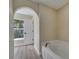 Bright bathroom with a corner tub, neutral walls, gray flooring, and natural light at 2004 Prescott Blvd, Deltona, FL 32738