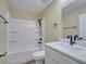 Bathroom features a tub with shower, a white vanity with dark fixtures and a toilet at 2004 Prescott Blvd, Deltona, FL 32738