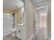 Clean bathroom features a tub, a white vanity with black handles and a toilet at 2004 Prescott Blvd, Deltona, FL 32738