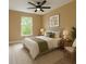 Cozy bedroom features a comfortable bed with nightstands, decor, and a large window at 2004 Prescott Blvd, Deltona, FL 32738
