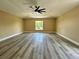 Large bedroom with luxury vinyl flooring, a ceiling fan, and abundant natural light at 2004 Prescott Blvd, Deltona, FL 32738
