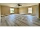 Large bedroom with luxury vinyl flooring, two windows, and neutral paint at 2004 Prescott Blvd, Deltona, FL 32738