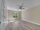Bedroom features a ceiling fan and a large window to the outdoors at 2004 Prescott Blvd, Deltona, FL 32738
