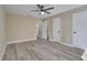 Bedroom features a ceiling fan, multiple windows and doors at 2004 Prescott Blvd, Deltona, FL 32738