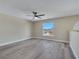 Spacious bedroom features gray flooring and a ceiling fan with a view of the exterior at 2004 Prescott Blvd, Deltona, FL 32738