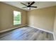 Bedroom with luxury vinyl flooring, a ceiling fan, and abundant natural light at 2004 Prescott Blvd, Deltona, FL 32738