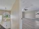 Bonus room with gray flooring and a ceiling fan, adjacent to a hallway and staircase at 2004 Prescott Blvd, Deltona, FL 32738