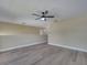 Large bonus room with neutral walls and gray flooring features a ceiling fan for added comfort at 2004 Prescott Blvd, Deltona, FL 32738