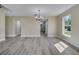 An airy dining room boasting hardwood floors, large windows, and a modern chandelier at 2004 Prescott Blvd, Deltona, FL 32738