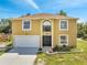 Charming two-story home boasts a two-car garage, a well-manicured lawn, and an arched entryway at 2004 Prescott Blvd, Deltona, FL 32738