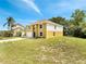 A charming two-story house featuring an attached two-car garage and an arched entryway at 2004 Prescott Blvd, Deltona, FL 32738