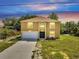 Charming two-story home boasting a large front yard, a two-car garage, and an arched entryway at 2004 Prescott Blvd, Deltona, FL 32738