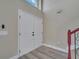 Inviting foyer featuring hardwood floors, a staircase, and a double-door entryway at 2004 Prescott Blvd, Deltona, FL 32738