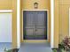 Close-up of elegant double front doors with modern hardware and manicured landscaping at 2004 Prescott Blvd, Deltona, FL 32738