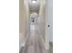 Hallway features gray flooring, neutral walls, and an archway leading to the bonus room at 2004 Prescott Blvd, Deltona, FL 32738