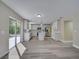 Bright kitchen with gray wood-look floors, white cabinets, an island with pendant lights, and stainless steel appliances at 2004 Prescott Blvd, Deltona, FL 32738