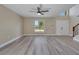 A spacious living room featuring hardwood floors, a staircase, and a double-door entryway at 2004 Prescott Blvd, Deltona, FL 32738