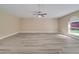 Spacious living room with a ceiling fan and a large window providing natural light at 2004 Prescott Blvd, Deltona, FL 32738
