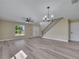 Open living room featuring new floors, ceiling fan and decorative lighting fixture at 2004 Prescott Blvd, Deltona, FL 32738