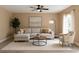 Bright living room featuring a comfortable sofa, accent chair, decor, and a large window at 2004 Prescott Blvd, Deltona, FL 32738