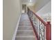 Staircase with decorative iron railing and wood-look stairs leading to the upper level at 2004 Prescott Blvd, Deltona, FL 32738