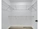 White walk-in closet features metal shelving for organized storage with gray flooring at 2004 Prescott Blvd, Deltona, FL 32738