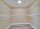 Spacious walk-in closet with wire shelving and durable wood-look flooring at 2004 Prescott Blvd, Deltona, FL 32738