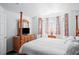 Comfortable bedroom featuring a four-poster bed, soft lighting, and neutral decor at 202 Aylesbury Ln, Davenport, FL 33837
