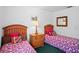 Bright bedroom featuring twin beds with decorative floral patterned bedding at 202 Aylesbury Ln, Davenport, FL 33837