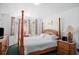 Comfortable bedroom with four-poster bed and large windows at 202 Aylesbury Ln, Davenport, FL 33837