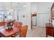 Bright, open dining room with a wooden table set adjacent to the kitchen and living areas at 202 Aylesbury Ln, Davenport, FL 33837