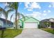 Charming, mint-green single-Gathering home with a well-maintained lawn and a two-car garage at 202 Aylesbury Ln, Davenport, FL 33837
