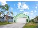 Charming, mint-green single-Gathering home with a well-maintained lawn and a two-car garage at 202 Aylesbury Ln, Davenport, FL 33837