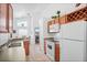 Functional kitchen features a double sink, white appliances, and views into the dining area at 202 Aylesbury Ln, Davenport, FL 33837