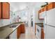 Bright kitchen featuring wood cabinets, tile floors, and stainless-steel appliances at 202 Aylesbury Ln, Davenport, FL 33837