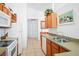 Well-lit kitchen with tile flooring, wood cabinets and modern appliances at 202 Aylesbury Ln, Davenport, FL 33837