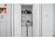A small laundry room with a washer and dryer behind bi-fold doors at 202 Aylesbury Ln, Davenport, FL 33837