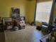 This bedroom features neutral paint, tile floor and a window at 209 Silas Phelps W Ct, Orlando, FL 32828