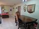 Dining Room with table, tiled floor, view of the foyer, and connected living room area at 209 Silas Phelps W Ct, Orlando, FL 32828