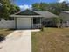 Charming single-story home featuring a well-maintained lawn, attached garage, and welcoming front entrance at 209 Silas Phelps W Ct, Orlando, FL 32828