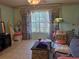 Living room area with couch, statue, and large window with light floral patterned drapes at 209 Silas Phelps W Ct, Orlando, FL 32828