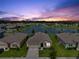 Aerial view of a home overlooking a serene lake with community park in a residential neighborhood at 3348 Perennial Ln, Kissimmee, FL 34746