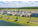 Aerial view of the community featuring manicured lawns and a pond at 3348 Perennial Ln, Kissimmee, FL 34746