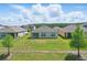 Backyard featuring a well-manicured lawn and two young trees at 3348 Perennial Ln, Kissimmee, FL 34746