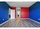 Bedroom featuring wood-look floors, an open door to the ensuite bathroom, and a hallway closet at 3348 Perennial Ln, Kissimmee, FL 34746