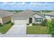 Charming single-story home with a well-manicured lawn and a two-car garage at 3348 Perennial Ln, Kissimmee, FL 34746