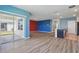 Open-concept living area with modern flooring, a slider to the patio, and an island at 3348 Perennial Ln, Kissimmee, FL 34746