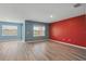 Spacious living room with wood-look floors and plenty of natural light from the large windows with water views at 3348 Perennial Ln, Kissimmee, FL 34746